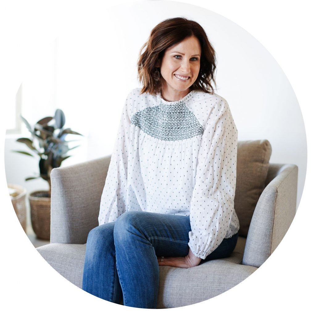 circle photo of life coach Minda sitting on a gray couch